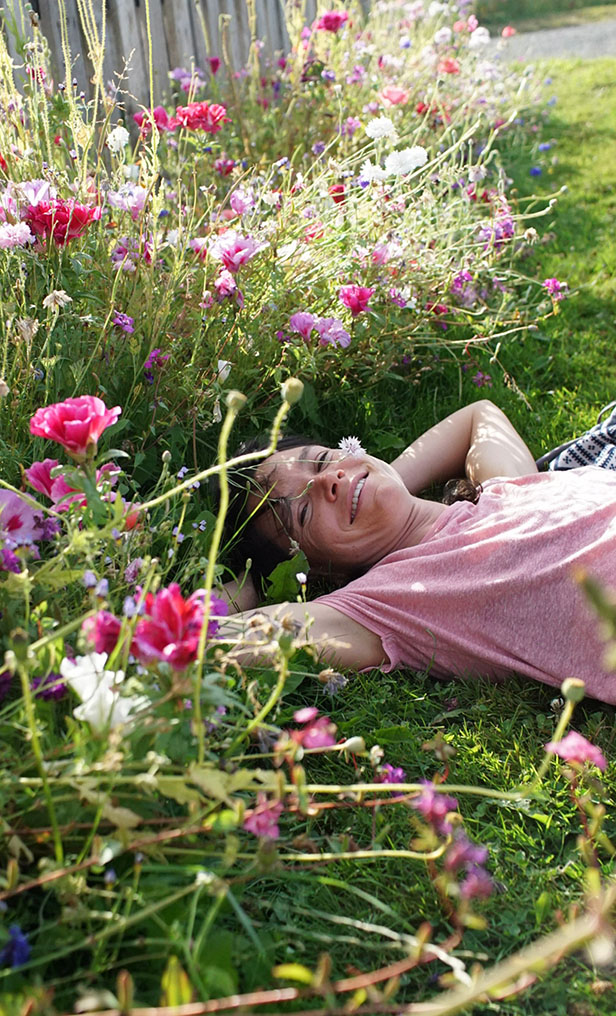A person lying in the flowers